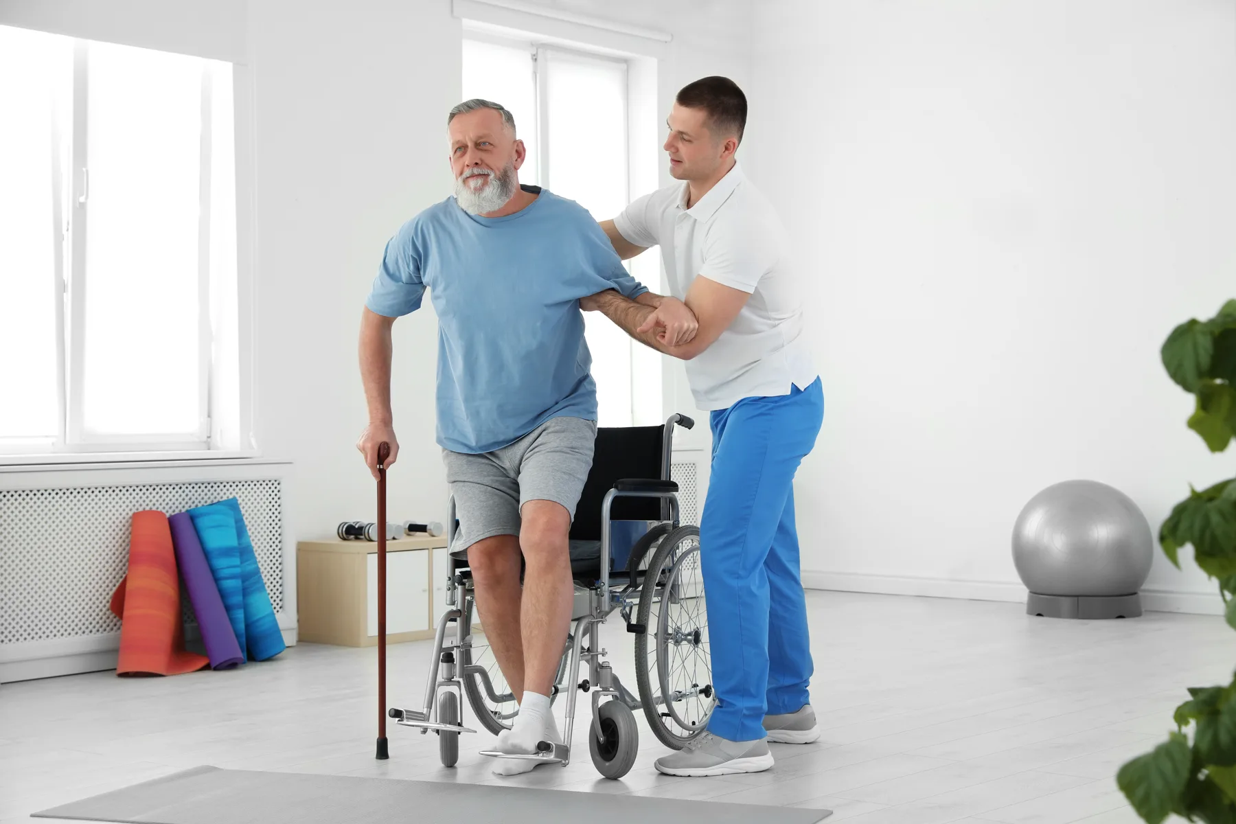 A patient walking with support during rehabilitation